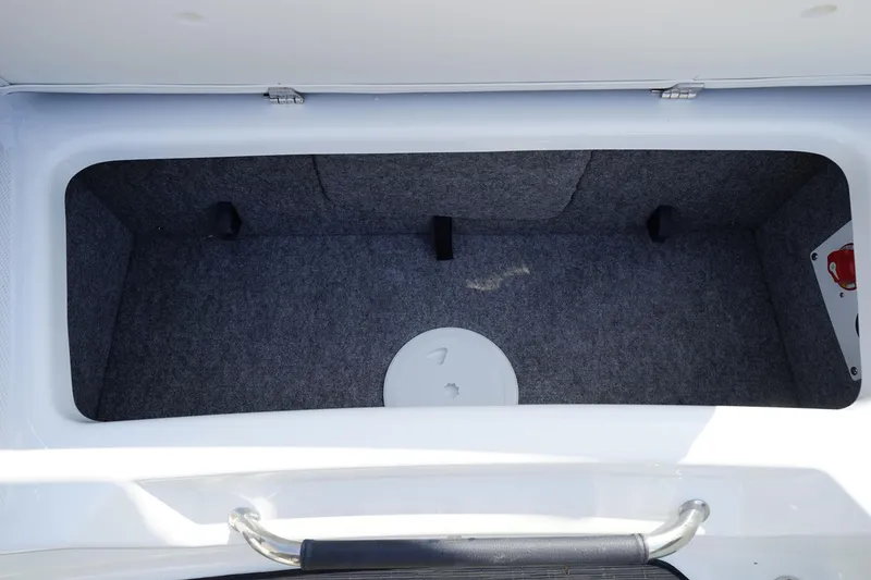 Slide: The Image of 2023 Four Winns H1 boat storage compartment with gray interior. - 23
