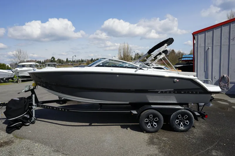 Slide: The Image of 2023 Four Winns H1 boat on a trailer, parked outdoors. - 3