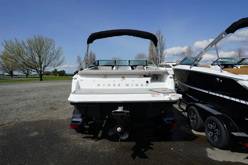 Slide: The Image of 2023 Four Winns H1 boat, rear view, parked on a trailer. - 5