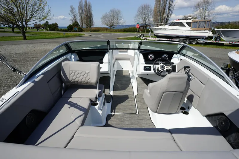 Slide: The Image of 2023 Four Winns H1 boat interior with modern seating and steering console. - 8