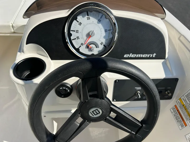 Slide: The Image of 2022 Bayliner Element E18 dashboard with steering wheel and speedometer. - 11