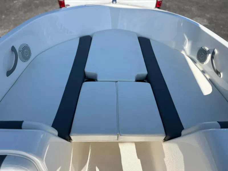 Slide: The Image of 2022 Bayliner Element E18 boat interior with cushioned seating. - 14