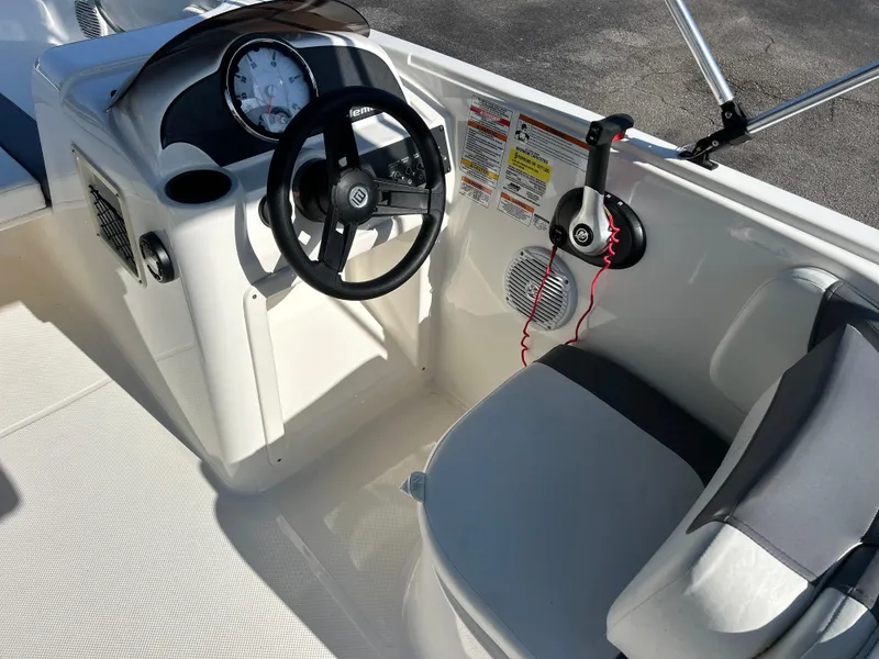 Slide: The Image of 2022 Bayliner Element E18 boat cockpit with steering wheel and seating. - 15
