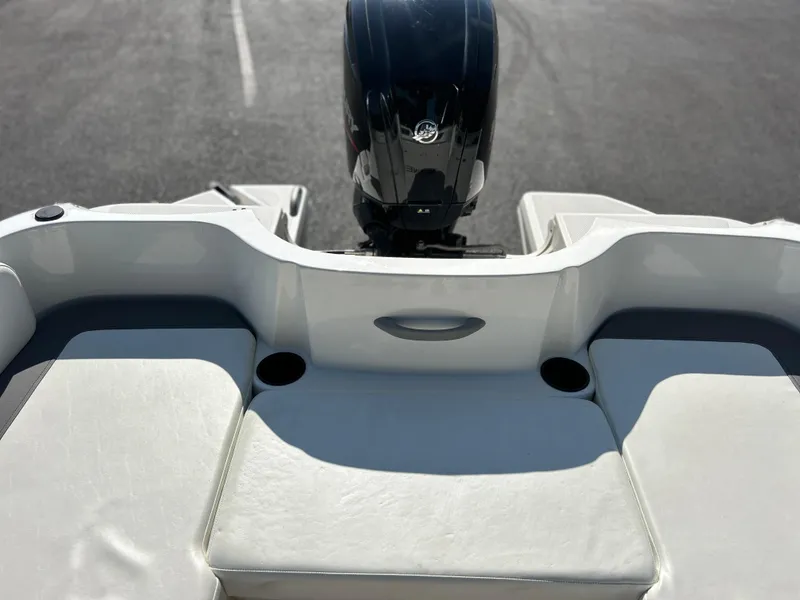 Slide: The Image of 2022 Bayliner Element E18 boat rear seating and outboard motor. - 18