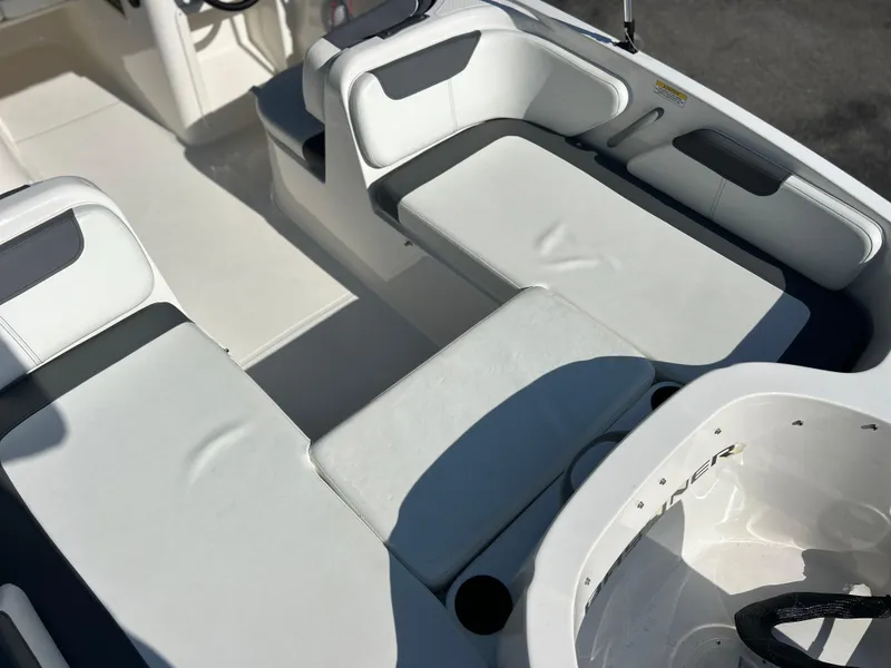 Slide: The Image of 2022 Bayliner Element E18 boat interior with white and gray seating. - 20