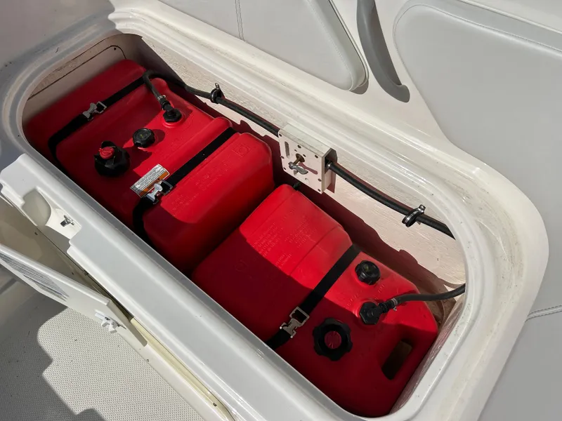 Slide: The Image of 2022 Bayliner Element E18 fuel storage compartment with red fuel tanks. - 26