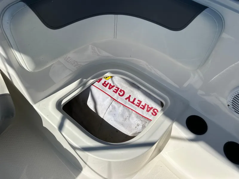 Slide: The Image of 2022 Bayliner Element E18 boat storage compartment with safety gear. - 28
