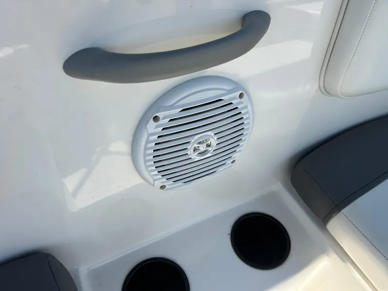 Slide: The Image of Bayliner Element E18 2022 boat interior with speaker and cup holders. - 33