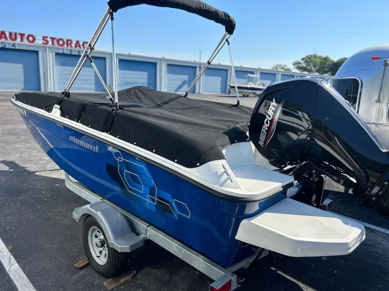 Slide: The Image of 2022 Bayliner Element E18 boat with Mercury outboard motor on trailer. - 34