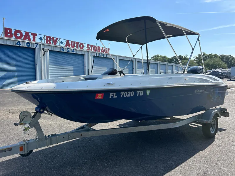 Slide: The Image of 2022 Bayliner Element E18 boat on trailer at storage facility. - 7