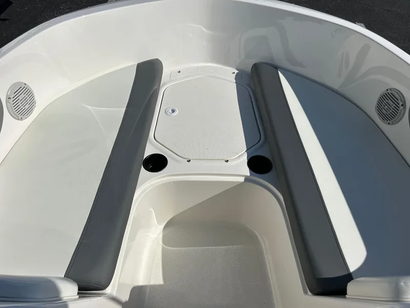 Slide: The Image of 2022 Bayliner Element E18 boat interior seating area with storage compartment. - 9