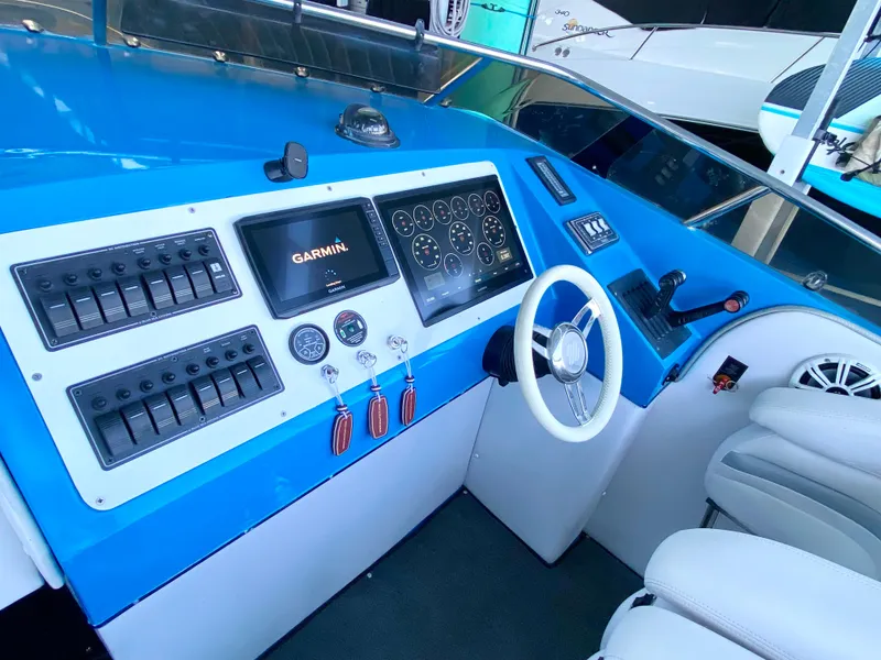 Slide: The Image of 1988 Warlock 37 Cat Cruiser cockpit with Garmin navigation system and modern controls. - 10