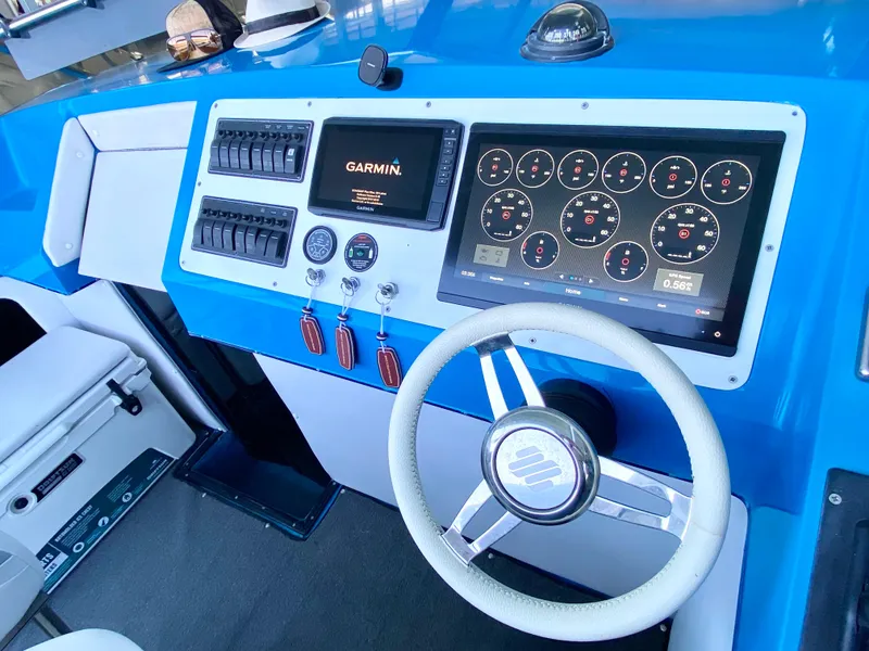 Slide: The Image of 1988 Warlock 37 Cat Cruiser dashboard with Garmin navigation and modern controls. - 11