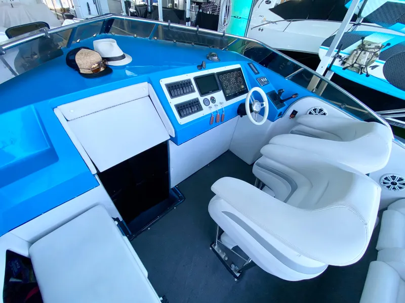 Slide: The Image of 1988 Warlock 37 Cat Cruiser cockpit with white seats and blue dashboard. - 12
