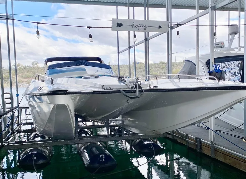 Slide: The Image of 1988 Warlock 37 Cat Cruiser docked in a marina. - 21