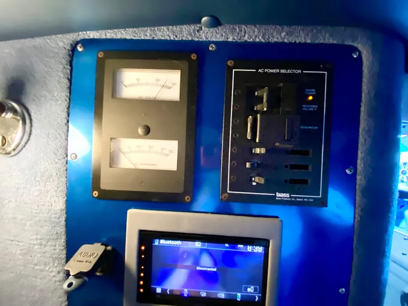 Slide: The Image of Control panel of a 1988 Warlock 37 Cat Cruiser with gauges and Bluetooth display. - 27