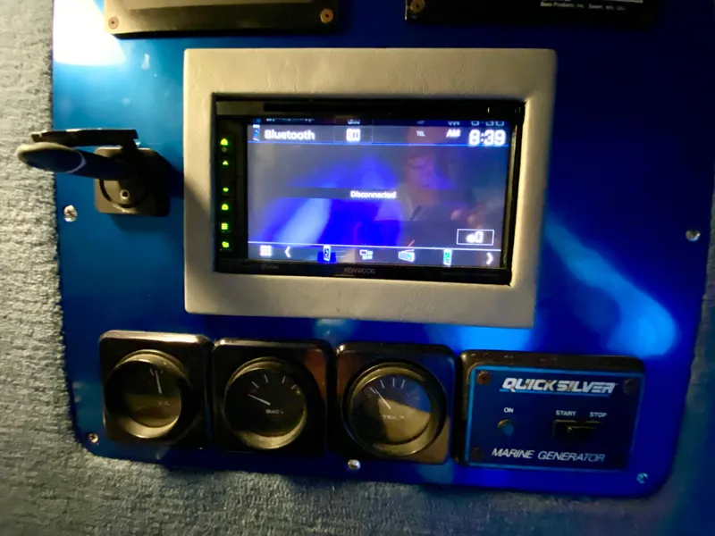 Slide: The Image of Control panel of a 1988 Warlock 37 Cat Cruiser with Bluetooth display and marine generator. - 28