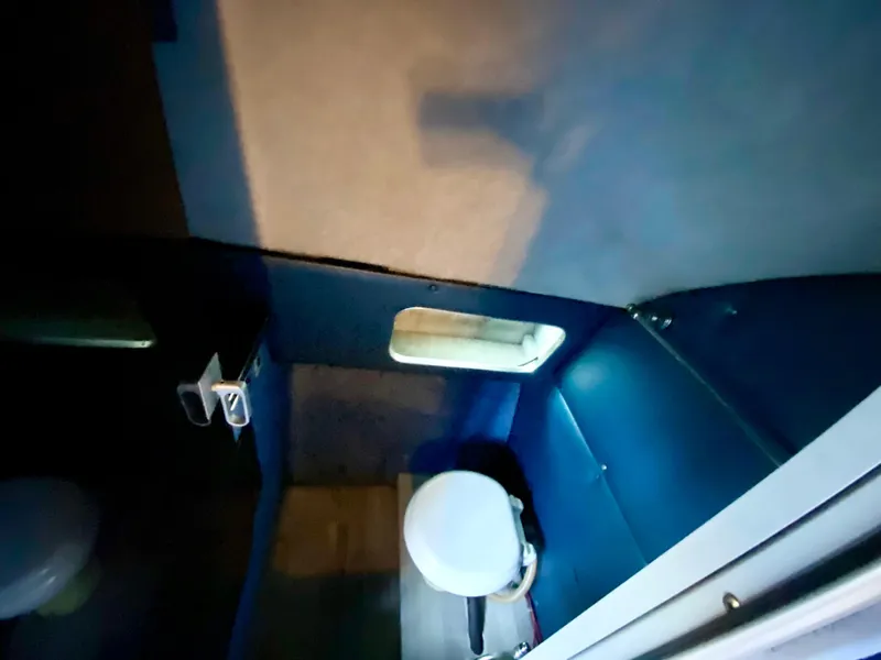 Slide: The Image of 1988 Warlock 37 Cat Cruiser interior bathroom with toilet and small window. - 29