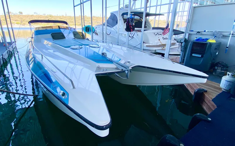 Slide: The Image of 1988 Warlock 37 Cat Cruiser docked at a marina. - 3