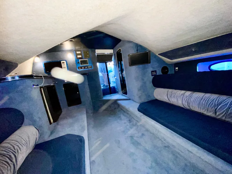 Slide: The Image of Interior of 1988 Warlock 37 Cat Cruiser with blue upholstery and modern amenities. - 33