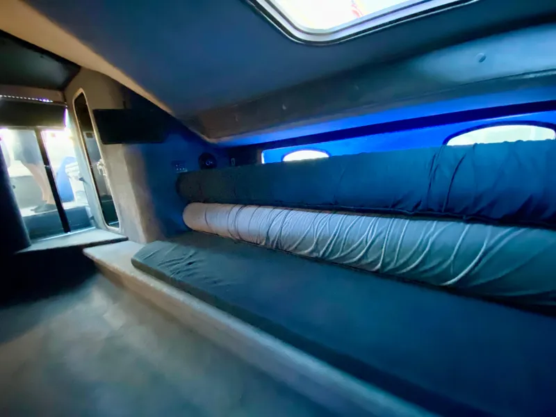 Slide: The Image of Interior of 1988 Warlock 37 Cat Cruiser with cushioned seating and windows. - 35