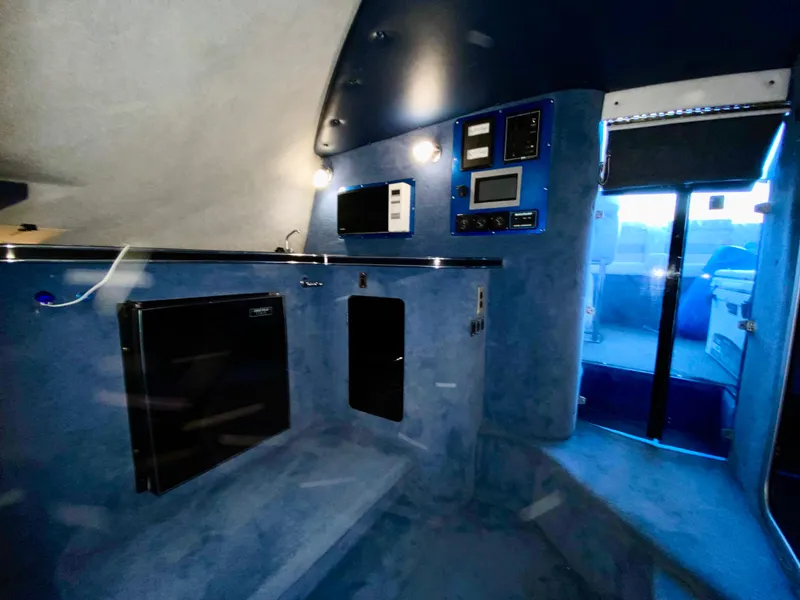 Slide: The Image of Interior of 1988 Warlock 37 Cat Cruiser with modern amenities and blue lighting. - 36