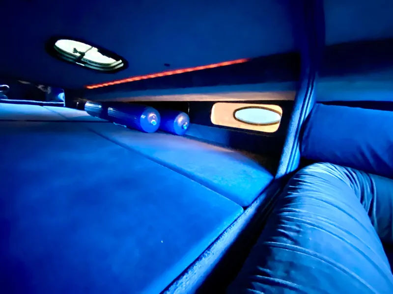 Slide: The Image of Interior cabin of 1988 Warlock 37 Cat Cruiser with blue lighting. - 38