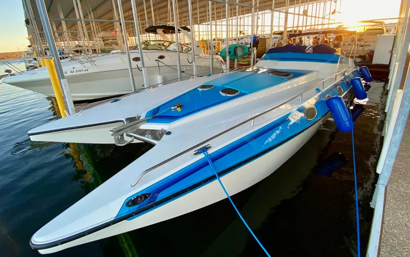 Slide: The Image of 1988 Warlock 37 Cat Cruiser docked in marina at sunset. - 4