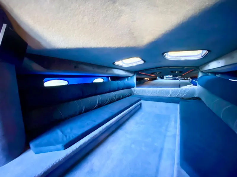 Slide: The Image of Interior of 1988 Warlock 37 Cat Cruiser with blue seating and skylights. - 40