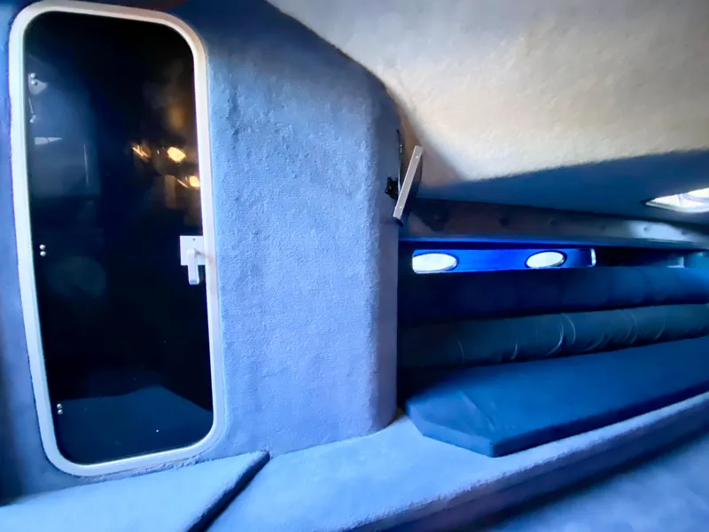 Slide: The Image of Interior cabin of a 1988 Warlock 37 Cat Cruiser boat with blue upholstery. - 41