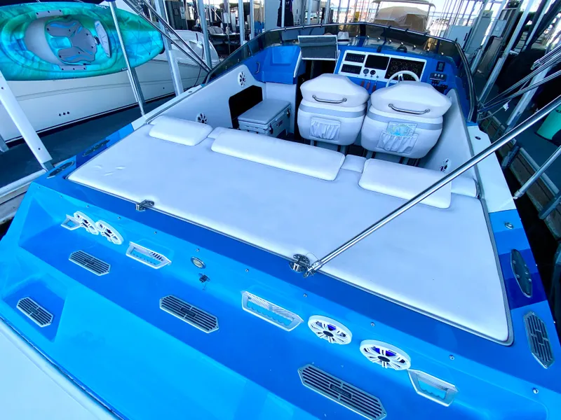 Slide: The Image of 1988 Warlock 37 Cat Cruiser boat interior with white seating and blue accents. - 8