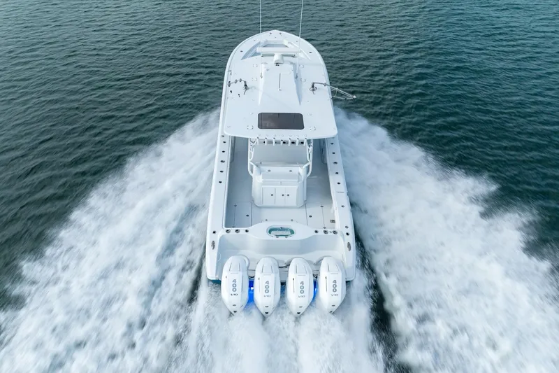 Slide: The Image of 2024 Yellowfin 42 boat with quad outboard engines cruising on water. - 12
