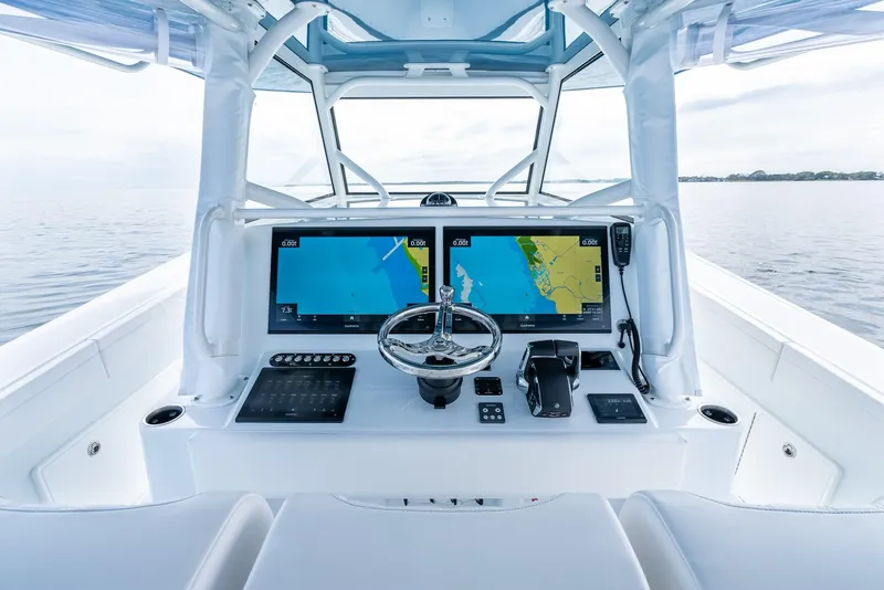 Slide: The Image of 2024 Yellowfin 42 boat cockpit with dual navigation screens and steering wheel. - 15