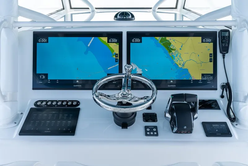 Slide: The Image of 2024 Yellowfin 42 boat dashboard with dual navigation screens and controls. - 16