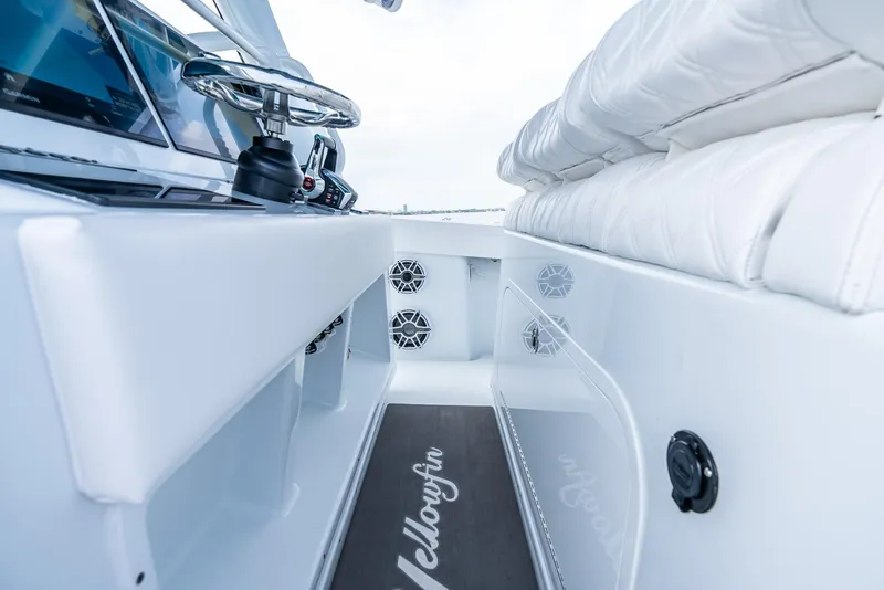 Slide: The Image of 2024 Yellowfin 42 boat interior with white seating and steering console. - 19
