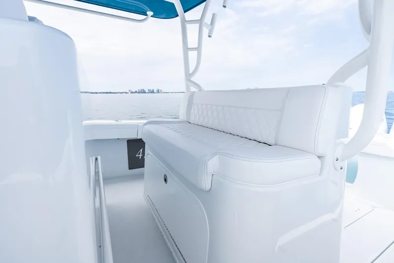 Slide: The Image of 2024 Yellowfin 42 boat with white cushioned seating and ocean view. - 23
