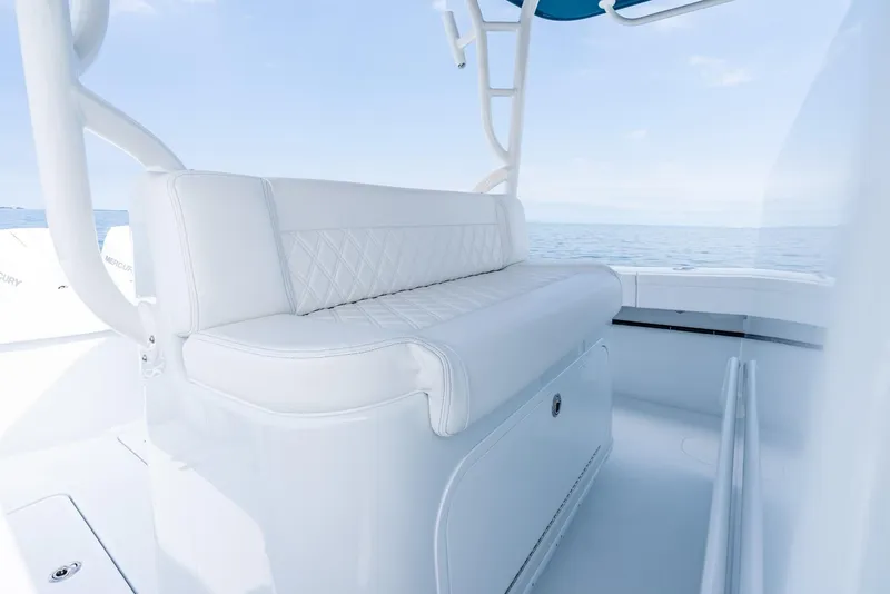 Slide: The Image of 2024 Yellowfin 42 boat with white cushioned seating and ocean backdrop. - 24