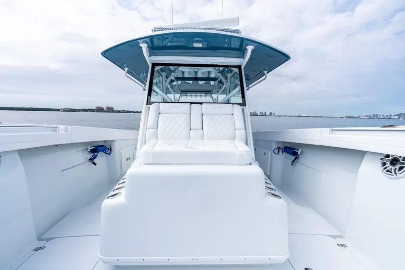 Slide: The Image of 2024 Yellowfin 42 boat with white seating and blue accents on open water. - 28