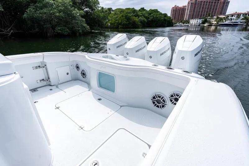 Slide: The Image of 2024 Yellowfin 42 boat with quad Mercury outboard engines on a calm waterway. - 33