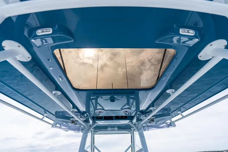 Slide: The Image of 2024 Yellowfin 42 boat with a sleek blue canopy and modern design. - 39