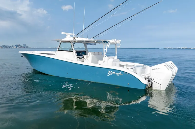 Slide: The Image of 2024 Yellowfin 42 boat with blue hull on calm water. - 5