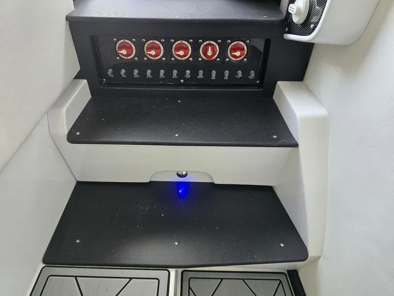 Slide: The Image of 2024 Nor-Tech 452 Super Fish control panel with red switches and black steps. - 10