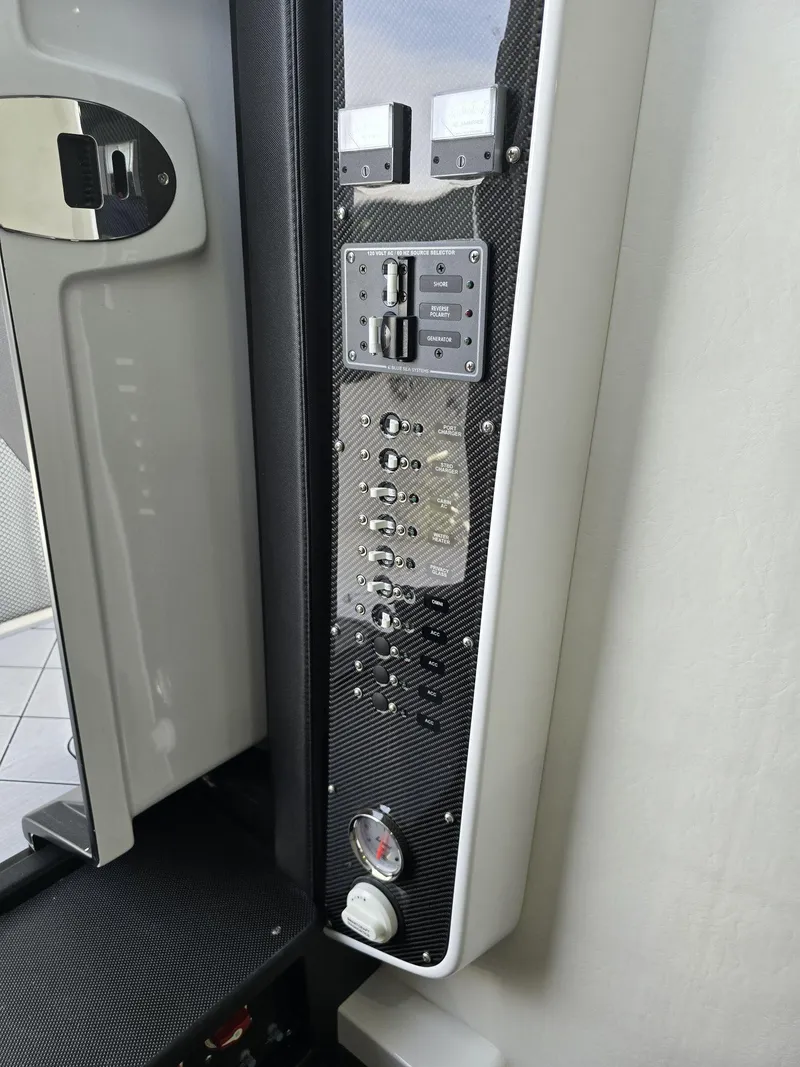 Slide: The Image of Control panel of 2024 Nor-Tech 452 Super Fish boat with switches and gauges. - 13