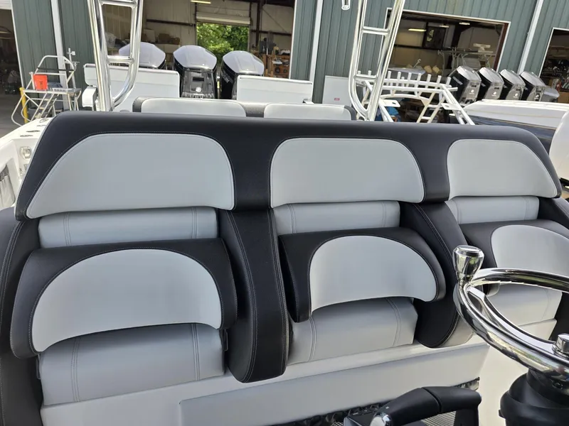 Slide: The Image of 2024 Nor-Tech 452 Super Fish boat seats and steering wheel in a marina. - 18