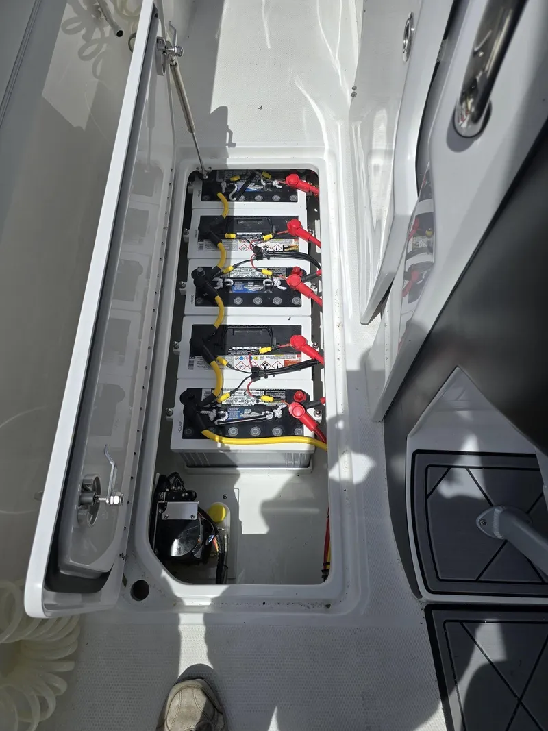 Slide: The Image of Battery compartment of 2024 Nor-Tech 452 Super Fish boat with multiple batteries and wiring. - 23