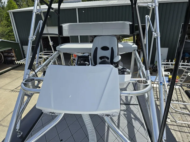 Slide: The Image of 2024 Nor-Tech 452 Super Fish boat helm station with seating and controls. - 4