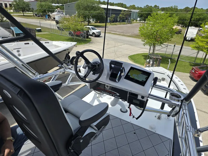 Slide: The Image of 2024 Nor-Tech 452 Super Fish boat helm with advanced navigation system and comfortable seating. - 5