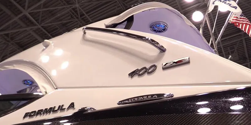 Slide: The Image of 2015 Formula 400 FX8 boat at an indoor exhibition, showcasing sleek design and branding. - 16