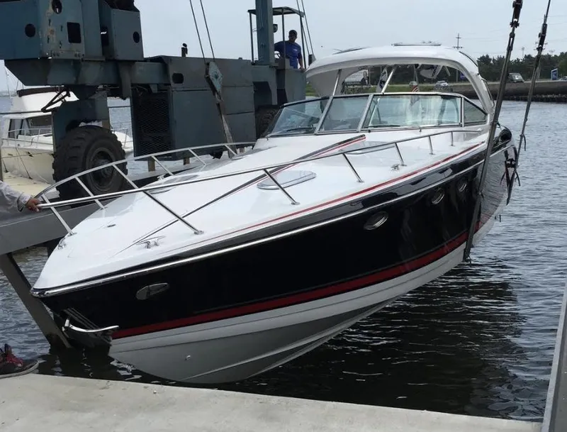 Slide: The Image of 2015 Formula 400 FX8 boat being lifted from the water at a marina. - 5