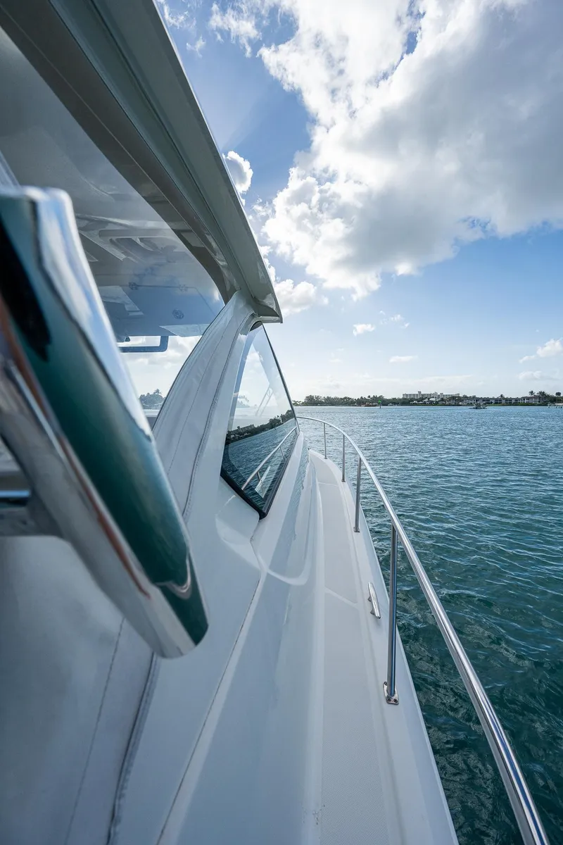 Slide: The Image of 2020 Pursuit OS 355 boat cruising on a sunny day. - 23